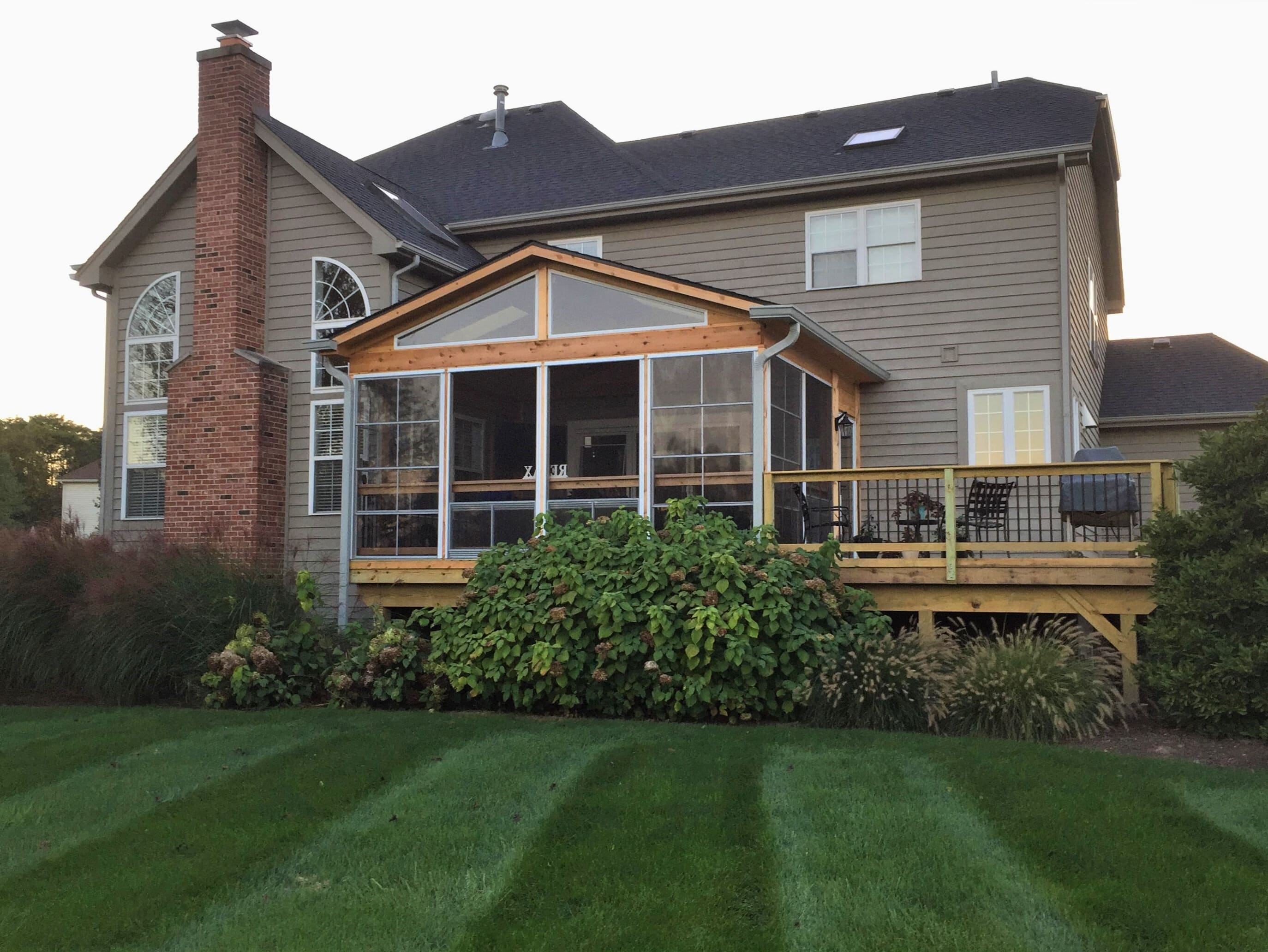 Screened porch and wood deck on the back of a home in St. Charles, IL.