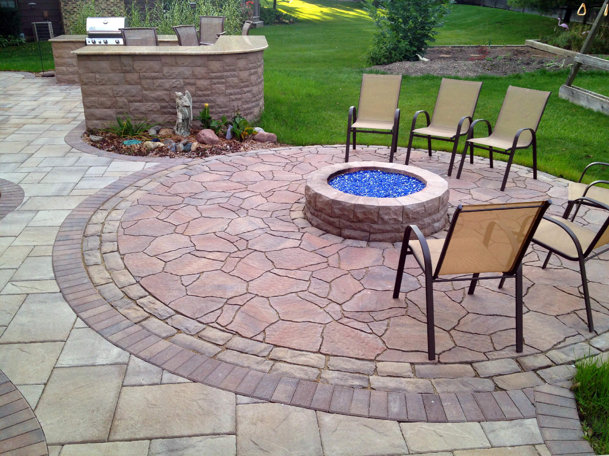 Custom patio with outdoor kitchen and fire pit