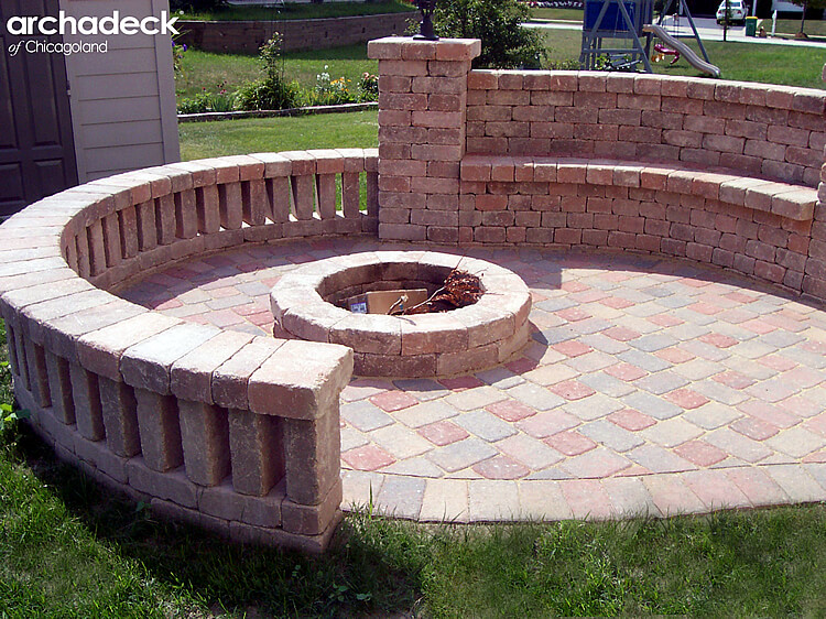 Custom built in fire pit with stone seat wall