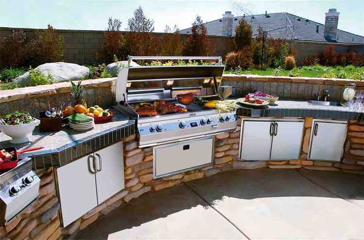 Custom outdoor kitchen with grilling steaks