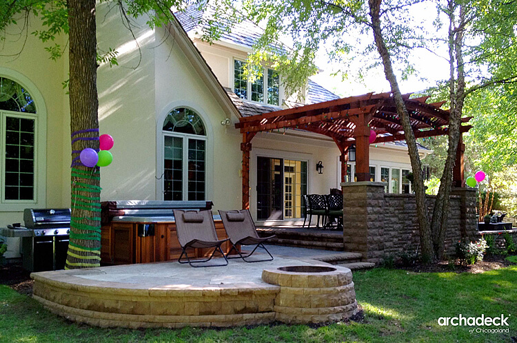 Custom raised patio with fire pit and pergola