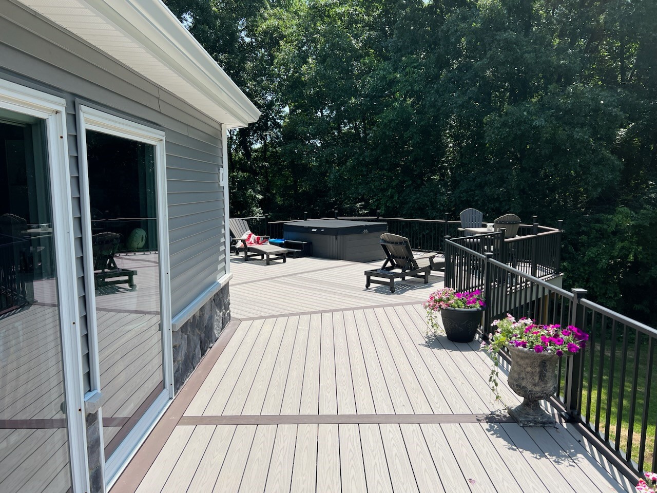 deck walkway leading to lounge chairs and hot tub