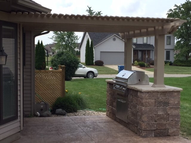 Custom patio with pergola and outdoor kitchen