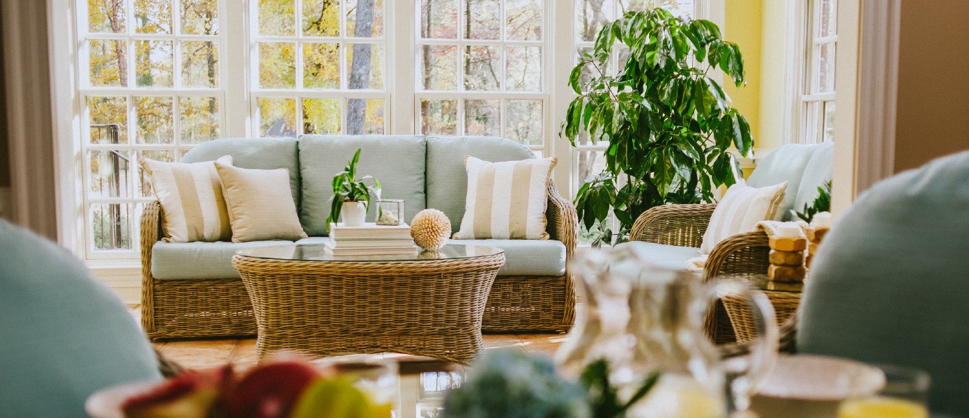 Bright, furnished sunroom interior.