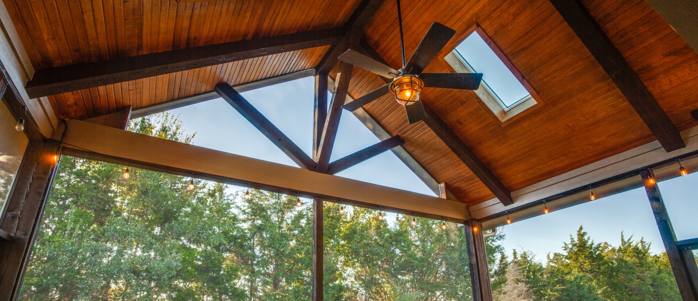 Screened porch awning with view of trees.