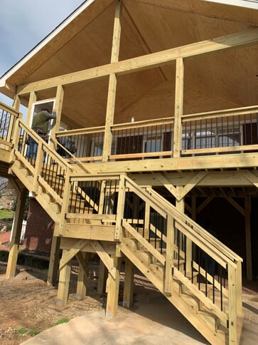 porch with wood stairs under construction