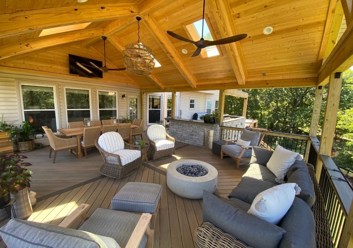 covered deck with open deck and outdoor kitchen