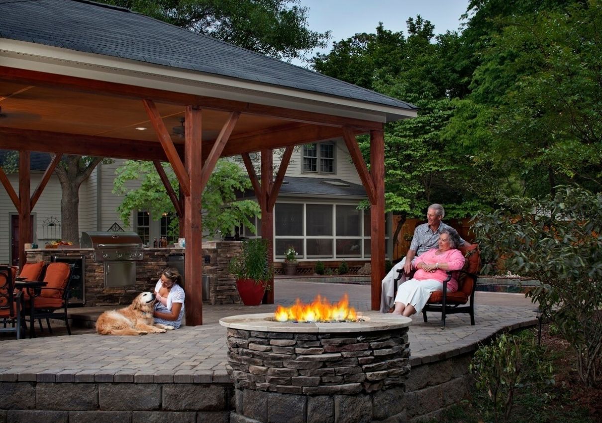 covered patio with outdoor kitchen and fire pit