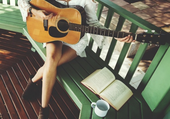 woman with guitar on deck