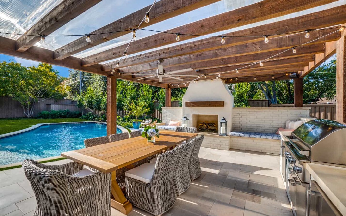 A patio with a pool and a table
Description automatically generated