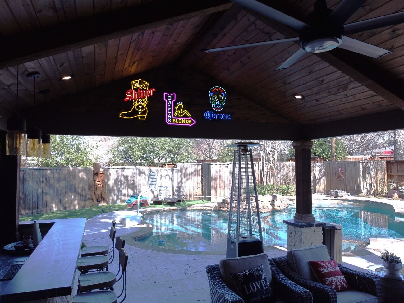 view from within patio cover looking into updated pool area Dallas TX