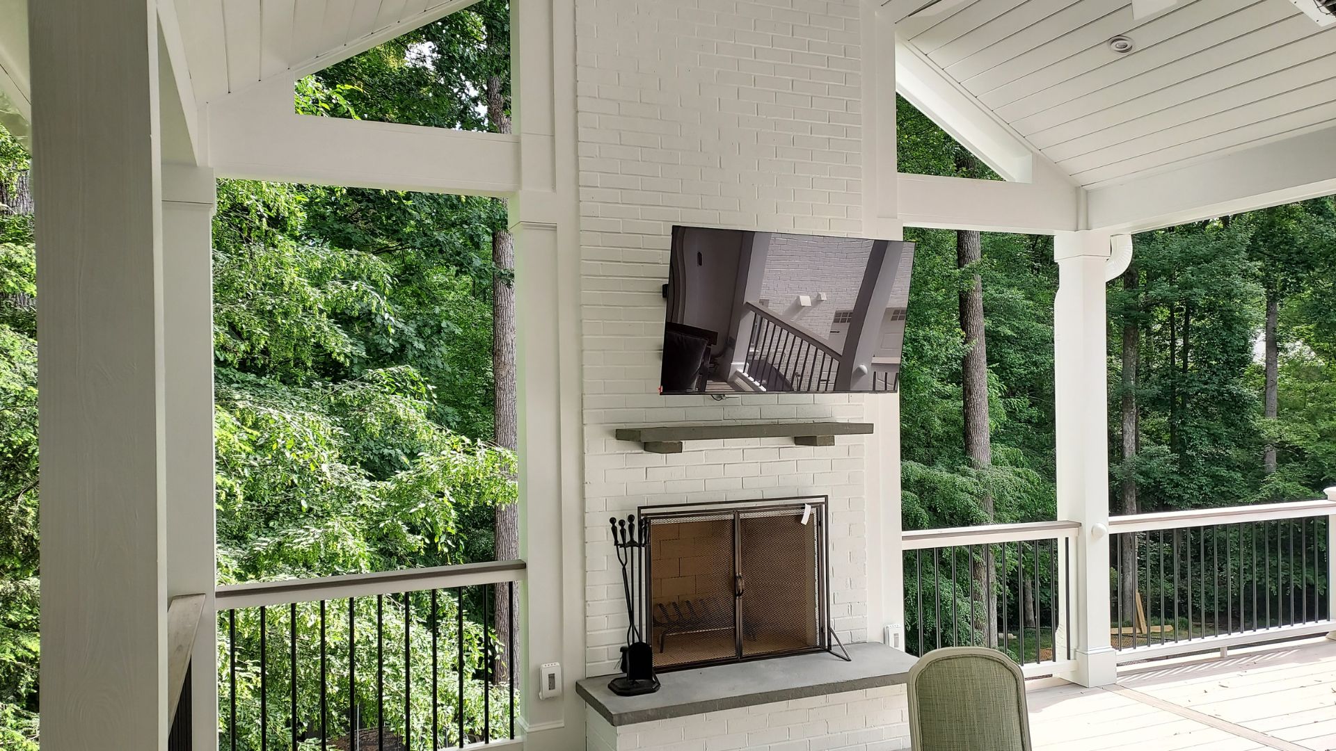 outdoor fireplace on covered porch and deck combination space