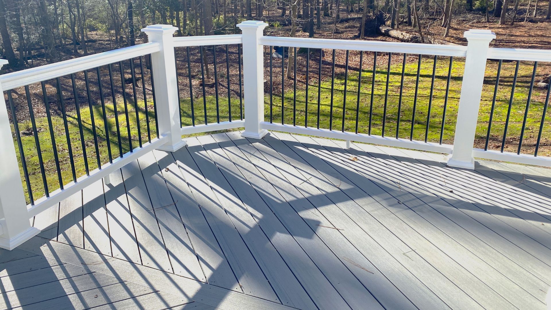 A deck with a white railing
AI-generated content may be incorrect.
