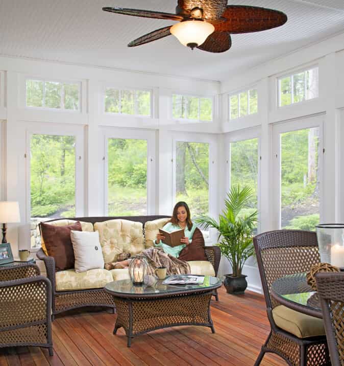 woman reading in sunroom