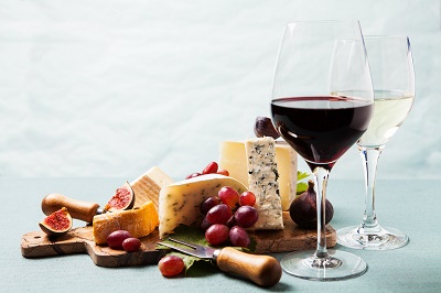 Pergolas-and-decks-go-together-like-fine-wine-and-good-cheese wine glasses next to cheese board