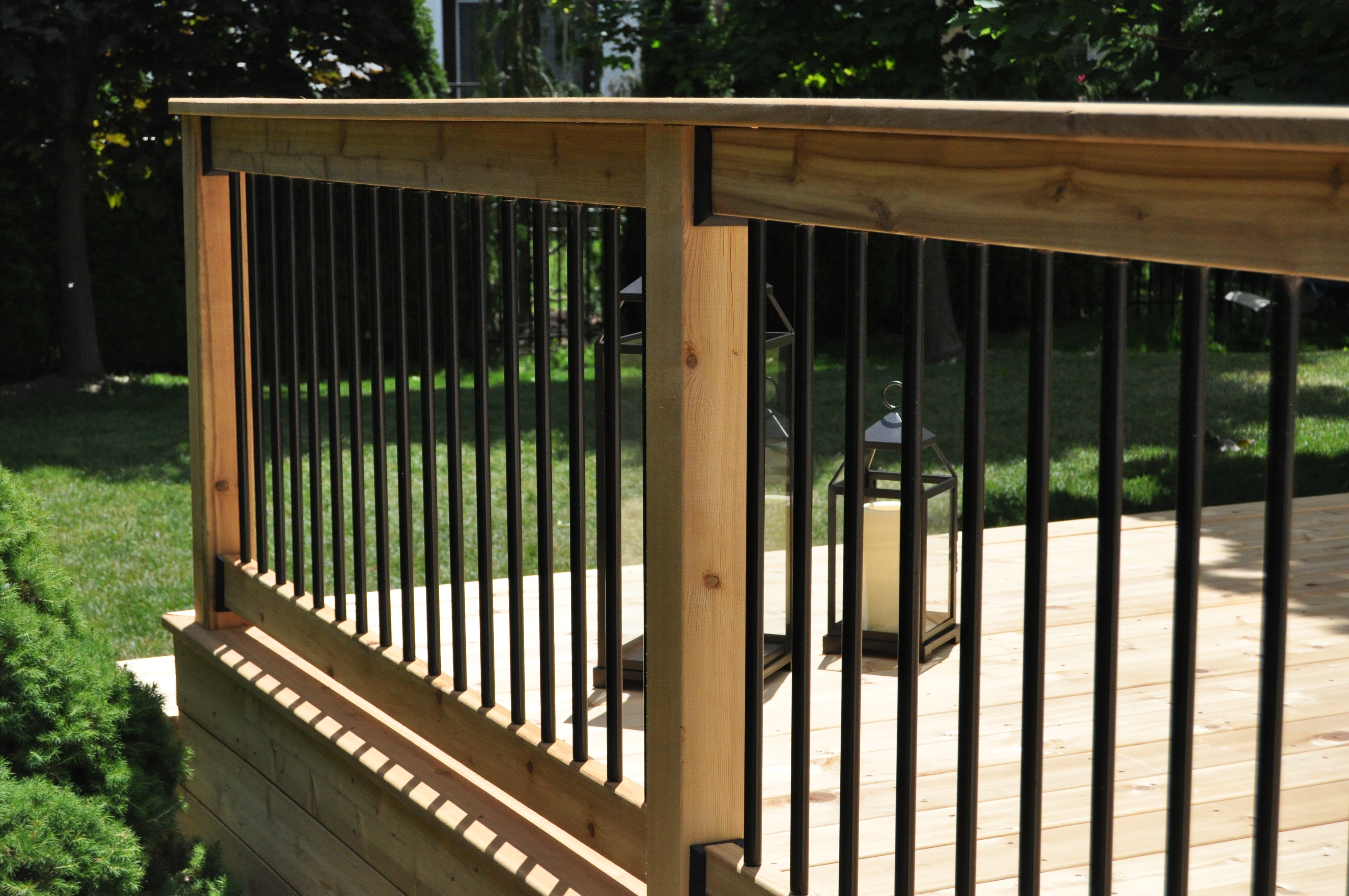 Slender profile black aluminum picket railing on deck.