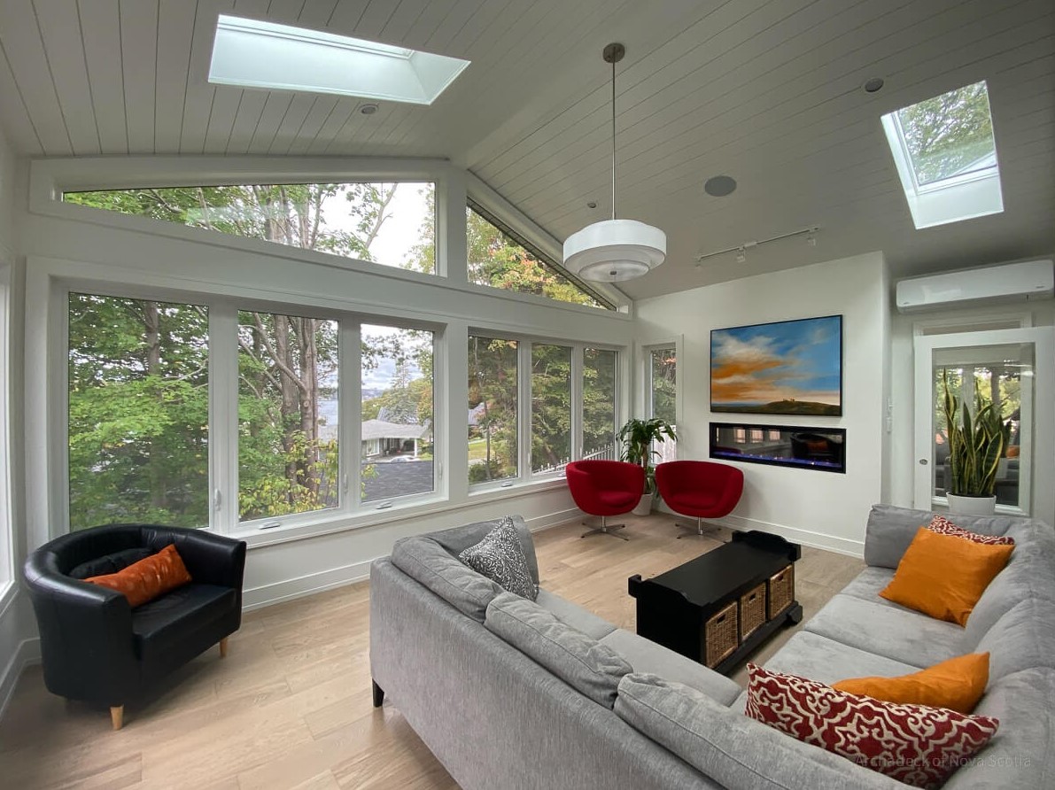 sunroom with plants and furniture and fireplace
